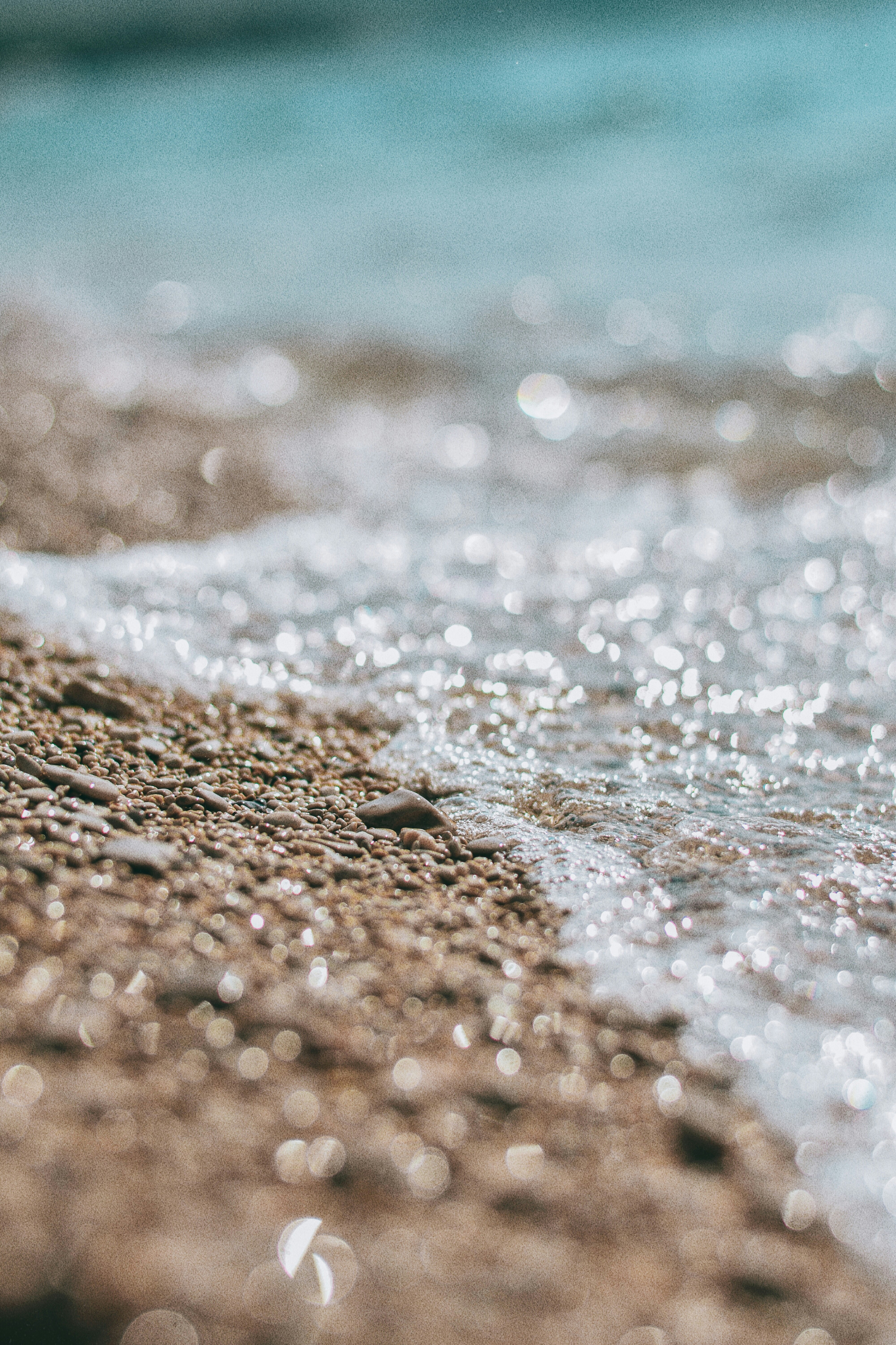 brown sand near body of water during daytime